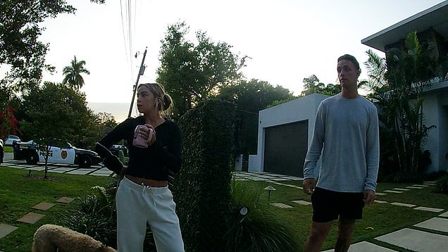 Miami quarterback Carson Beck and basketball star Hanna Cavinder calmly speak with police after luxury cars are stolen from their South Florida home