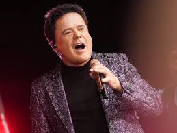 Donny Osmond surprises fans as he performs live in Las Vegas with an AI-generated version of his 14-year-old self