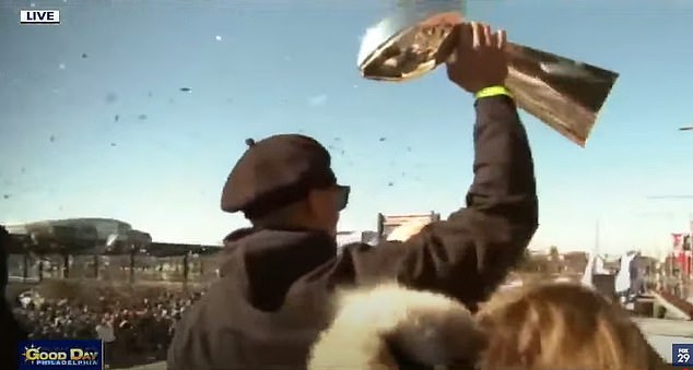 Jalen Hurts and Eagles teammates ride through Philadelphia in championship parade while fans cheer and relive Super Bowl triumph on giant screens