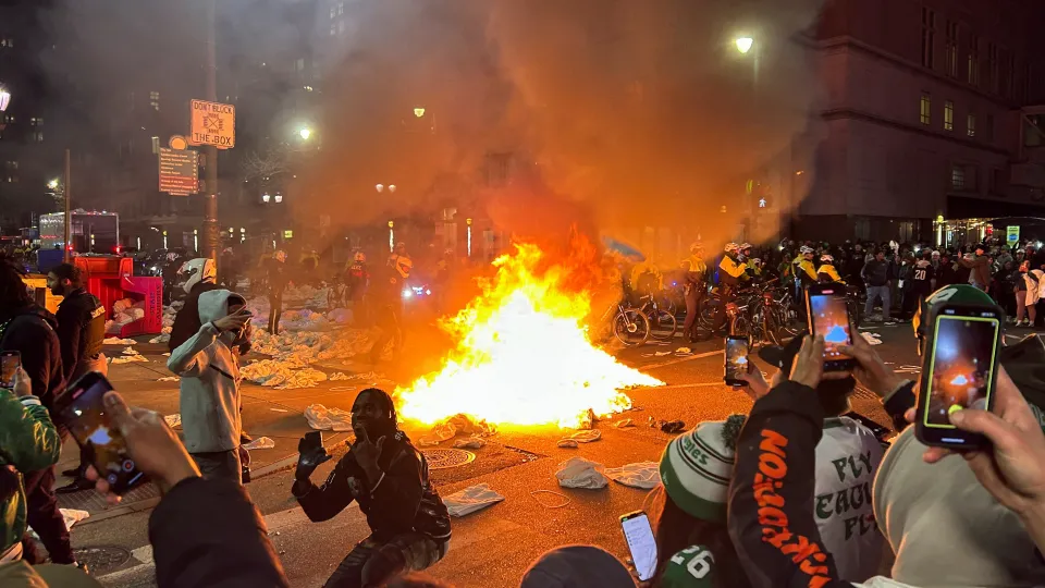 Jubilant Philadelphia Eagles supporters turn city streets into a massive party as Super Bowl win leads to climbing poles smashing lights and flipping cars