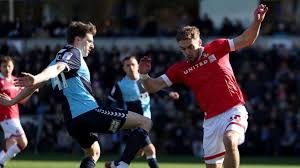 Wrexham and Wycombe’s League One Match Suspended Due to Medical Emergency Involving Supporter at the Stadium