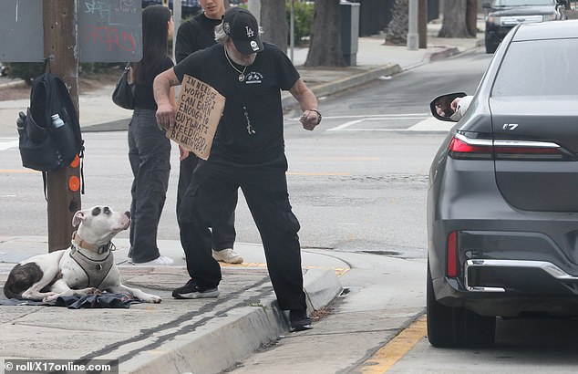 Hollywood star Ben Affleck surprises onlookers as he gives money to a homeless man from his car in Los Angeles before family outing