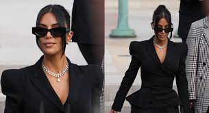 Kim Kardashian stuns on the streets of Beverly Hills as she steps out in a sheer black top after returning from emotional court testimony in Paris