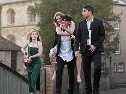 Oxford students stroll home in ball gowns and bow ties after dancing through the night at Balliol College’s Star Crossed Lovers May Ball