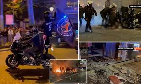 Paris Saint-Germain Fans Celebrate Victory Over Arsenal as Violent Clash Erupts in Paris Streets with Car Set on Fire