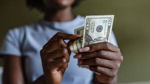 Americans chase extra income through side hustles as rising living costs in the United States leave full-time jobs unable to cover basic expenses