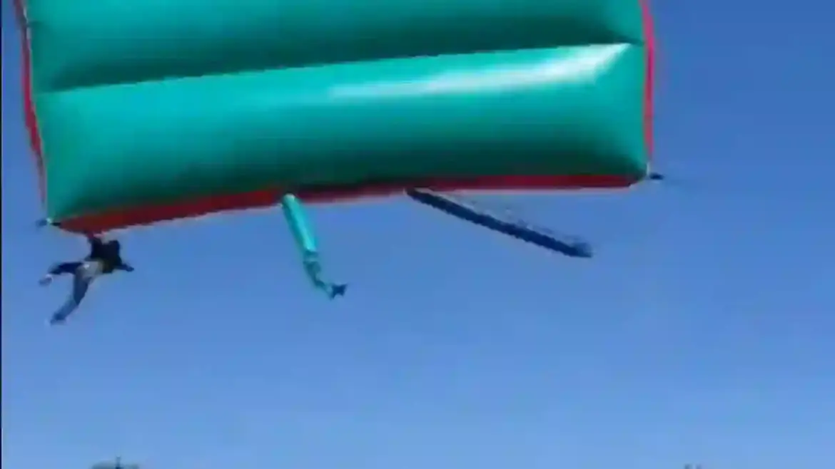 Strong gust of wind launches bouncy castle into the air with two children inside at school fundraiser in Krugersdorp South Africa