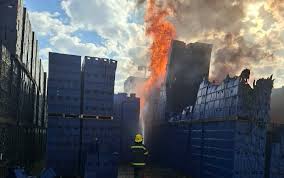 Emergency services contain fire as blaze spreads from grass to storage crates at South African Breweries in Soweto