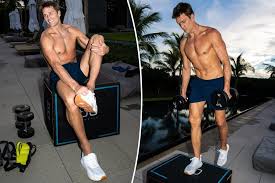 Tom Brady shows off shredded physique and promotes sneakers while working out shirtless in gym at 47 years old