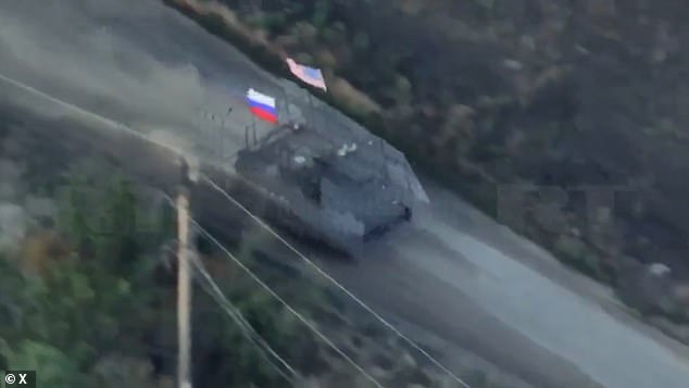 Russian troops parade a captured US armored vehicle in Zaporizhzhia