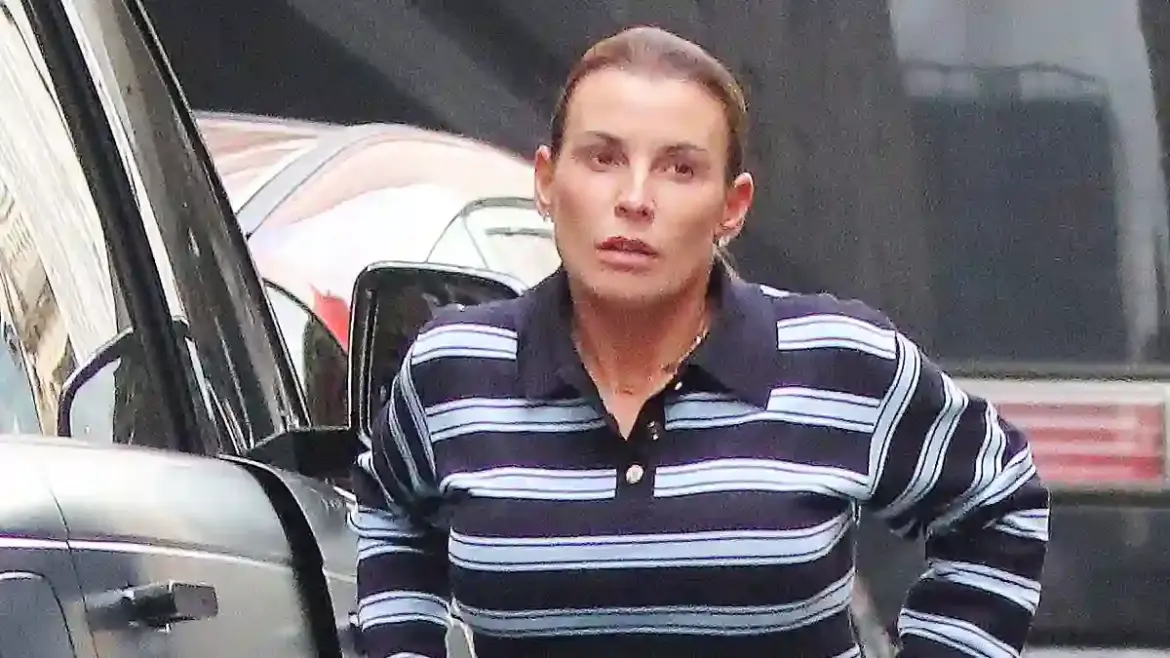 Coleen Rooney shows off her figure in blue jeans while leaving Indian restaurant with husband Wayne in Manchester