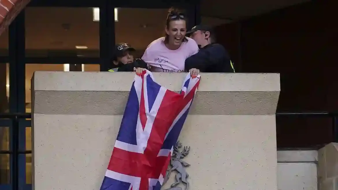 Police arrest organiser of migrant hotel protest after she flies Union flag at Epping District Council Civic Centre in Essex