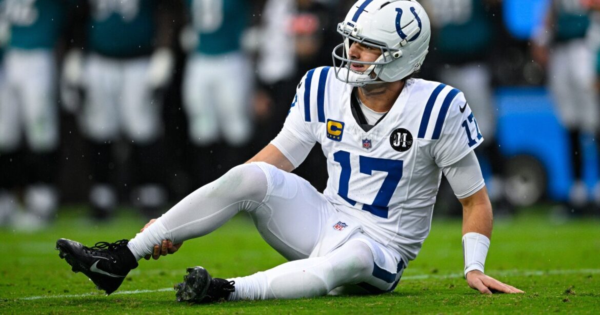 Indianapolis Colts quarterback Daniel Jones suffers injury and angrily strikes his helmet during game against Jacksonville Jaguars in Indianapolis