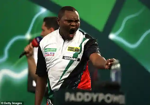 Kenyan Darts Player David Munyua Stuns 18th Seed Mike De Decker to Secure Historic Victory at Alexandra Palace in London