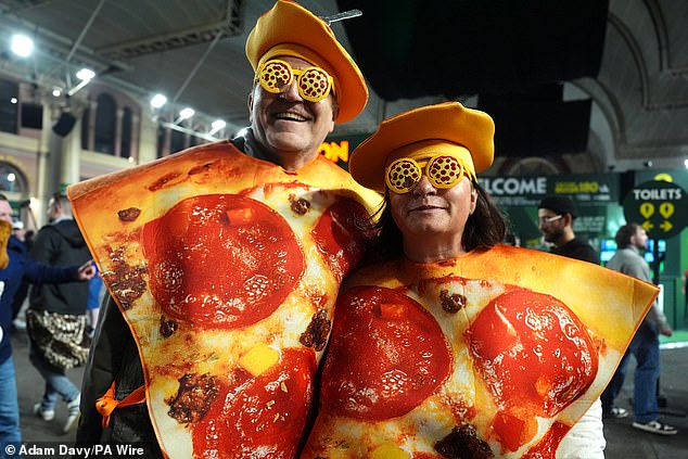 Fans pack Alexandra Palace to watch Luke Littler defend his World Darts Championship title amid colourful costumes and raucous atmosphere