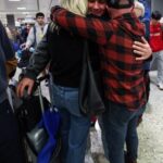 Aidan Korn hugs his parents, Karen and Jason Korn, at Dulles Airport in Virginia upon his safe return