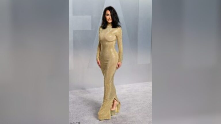 Kim Kardashian struggles to walk in towering heels and stuns fans at Vanity Fair Oscars party in Los Angeles