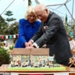 King Charles and Queen Camilla Slice Commemorative Cake at Eden Project in Cornwall with Playful Sword Antics