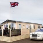 For many people, the word caravan still brings back memories of tight spaces, shared bathrooms, and late-night walks across chilly campsites. But that image is quickly becoming outdated. Today’s mobile homes are stepping into an entirely different class—think designer interiors, spacious layouts, and features you’d expect in a high-end property rather than something on wheels. Modern static caravans can stretch up to 60 feet wide, often dwarfing the size of a typical UK home. Inside, it’s not unusual to find freestanding bathtubs, vaulted ceilings, and carefully curated décor that rivals boutique hotels. A Royal Twist: Prince Andrew’s Unexpected Setup Perhaps the clearest sign of this shift comes from none other than Prince Andrew. The royal has reportedly embraced caravan living—at least temporarily—after placing a second-hand unit in the garden of Marsh Lodge on the Sandringham Estate. The property itself is still undergoing heavy renovation, leaving the caravan to serve a practical purpose. It’s believed to house his security team and provide a convenient base during site visits. Interestingly, the caravan—identified as a Willerby Meridian Lodge—was funded using money provided by King Charles III for living expenses. Even more surprising? Sources claim Andrew genuinely enjoys spending time there, suggesting a notable shift in lifestyle for the once high-profile royal. Not Just Royals: Celebrities Are Joining In Prince Andrew isn’t alone in warming to caravan life. TV presenter Josie Gibson has reportedly grown so fond of her mobile home setup that she wouldn’t mind living in one long-term. She moved into a caravan while her house underwent renovations—and ended up loving the simplicity and comfort it offers. This growing acceptance among public figures is helping reshape perceptions, turning caravans from a last-resort option into a lifestyle choice. The Rise of Affordable Luxury Homes Behind this transformation is a new generation of builders redefining what mobile homes can be. One standout is CS Vanguard Park Homes, a family-run business crafting high-end static homes at relatively accessible prices. Their homes start from around £48,000 and can climb to under £200,000—still far below traditional housing costs. Buyers are heavily involved in the design process, choosing layouts, finishes, and features to suit their tastes. From mirrored TVs to bespoke feature walls and air conditioning, these homes are anything but basic. Add in a 20-year waterproof warranty and modern appliances, and it’s easy to see why demand is growing. When Caravans Hit Millionaire Status At the extreme end of the market, caravans are even entering luxury real estate territory. A standout example emerged at Sandhills Holiday Park, where a holiday lodge was listed for a staggering £1.5 million. Despite offering under 1,000 square feet of space, the property included three bedrooms, sea views over Christchurch Harbour, and premium shared amenities like a heated pool and gym. While some critics dismissed it as overpriced, others pointed to its prime location as justification. Still, the listing sparked debate—especially given its limited lease and seasonal occupancy rules. A Palace on Wheels? Why Not Luxury caravans aren’t just about sleek modern design—they can also be playful and extravagant. In 2020, Parkdean Resorts unveiled a caravan styled after Buckingham Palace. Complete with chandeliers, gold-plated toilets, velvet thrones, and even royal-themed dog accessories, it offered guests a tongue-in-cheek taste of regal life—all for a surprisingly modest nightly rate. It proved that caravans can be both luxurious and fun, breaking every stereotype in the process. Impact and Consequences The growing popularity of high-end caravans is quietly reshaping the housing and holiday markets. For one, they offer a more affordable entry point into property ownership, especially as traditional home prices remain out of reach for many. They’re also influencing how people think about space and lifestyle—encouraging simpler, more flexible living arrangements. However, challenges remain, including planning permissions, land ownership issues, and concerns about long-term value compared to conventional homes. What’s Next? The future of caravans looks surprisingly bright. As designs become more sophisticated and demand increases, we may see mobile homes evolve into a mainstream housing solution rather than a niche alternative. With sustainability trends on the rise, there’s also potential for eco-friendly caravan developments—think solar-powered units and off-grid living options. Summary Caravans have undergone a dramatic transformation, shedding their outdated image in favor of luxury, flexibility, and affordability. From royal residents to everyday homeowners, more people are embracing the idea that living well doesn’t always require bricks and mortar. Bulleted Takeaways Modern caravans now rival traditional homes in design, comfort, and space Prince Andrew is reportedly using—and enjoying—a caravan during home renovations Celebrities like Josie Gibson are helping normalize caravan living Companies like CS Vanguard Park Homes offer customizable luxury homes at lower costs High-end caravans can reach eye-watering prices, such as the £1.5m lodge at Sandhills Holiday Park The trend signals a broader shift toward flexible, affordable, and stylish living solutions