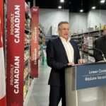 Secretary of State Wayne Long and store manager Rob Farrell