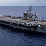 USS Abraham Lincoln Pulls Back From Iranian Coast Behind Oman's Mountains As Tensions Escalate In The Middle East