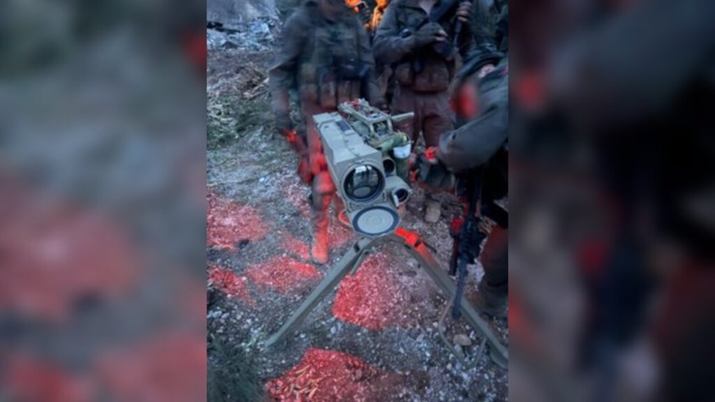 A launcher directed toward northern Israel, alongside anti-tank missiles and additional weapons used by Hezbollah