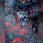 A launcher directed toward northern Israel, alongside anti-tank missiles and additional weapons used by Hezbollah