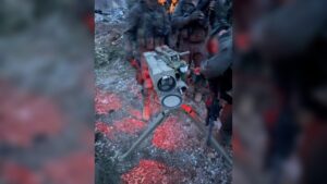 A launcher directed toward northern Israel, alongside anti-tank missiles and additional weapons used by Hezbollah