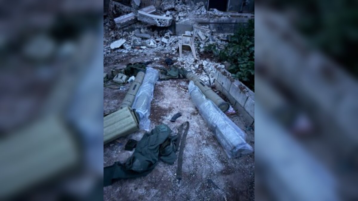A launcher directed toward northern Israel, alongside anti-tank missiles and additional weapons used by Hezbollah