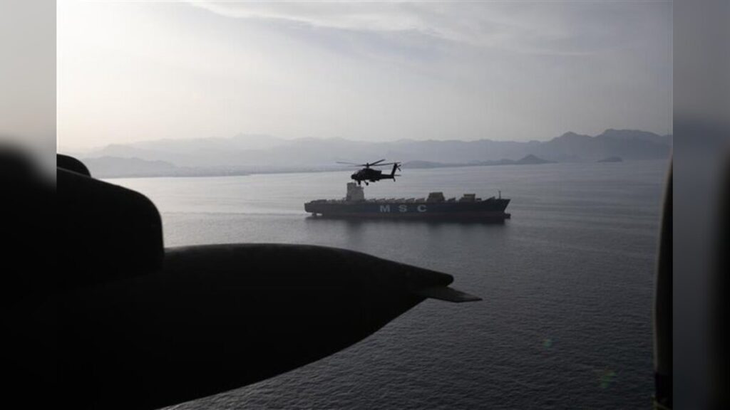 AH-64 Apaches fly above the Strait of Hormuz during a patrol
