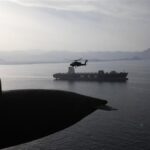 AH-64 Apaches fly above the Strait of Hormuz during a patrol