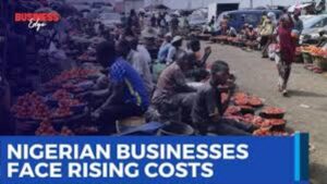Something is shifting across Nigeria’s business landscape—and companies are feeling it in real time. While the economy hasn’t stalled, the pace of growth is clearly slowing as multiple pressures begin to stack up. From rising inflation to unreliable electricity and tougher access to credit, businesses are now operating in a far more demanding environment. The challenge isn’t just staying profitable—it’s staying afloat while planning for the future. Growth Is Still There, But It’s Losing Steam On paper, economic activity remains positive. But beneath the surface, momentum is fading. Many companies across manufacturing, retail, and services say the same thing: costs are rising faster than revenues. That imbalance is forcing difficult choices. Should businesses increase prices and risk losing customers? Or absorb the costs and shrink their margins? For many, neither option is ideal. Inflation Continues to Bite Hard At the center of it all is inflation. Prices of goods and services remain elevated, pushing up the cost of nearly everything businesses rely on—raw materials, transportation, and wages. For manufacturers, the pain is even sharper. Many depend on imported inputs, and with the naira under pressure, the cost of sourcing materials from abroad has surged. What used to be manageable expenses are now major financial burdens. Power Supply Problems Refuse to Go Away If inflation is one headache, energy is another. Despite ongoing reforms, electricity supply across Nigeria remains inconsistent. That means businesses—large and small—are forced to generate their own power using diesel or petrol generators. But here’s the catch: fuel prices have risen significantly. So now, companies are spending far more just to keep the lights on. Energy is no longer a background expense—it’s becoming one of the biggest cost drivers. For many firms, money that should go into hiring, expansion, or upgrading equipment is instead being spent on fuel. Over time, that trade-off weakens productivity and slows growth. Borrowing Money Is Getting Harder Access to finance is also tightening. Interest rates are climbing, and banks are becoming more cautious about who they lend to. Small and medium-sized businesses are feeling the squeeze the most. These businesses often rely on short-term loans to keep operations running. Now, with stricter lending conditions, many are struggling to maintain inventory or fund day-to-day activities. Even large corporations aren’t immune. Higher borrowing costs are starting to eat into profits and delay investment plans. Businesses Are Being Forced Into Survival Mode Put it all together—inflation, energy costs, and limited financing—and you get shrinking profit margins across the board. Companies are becoming more cautious. Expansion plans are being delayed. Hiring is slowing. The focus has shifted from aggressive growth to efficiency and survival. Pricing has also become tricky. Passing costs to consumers sounds simple, but in reality, weak purchasing power limits how much businesses can increase prices without losing customers. Changing Consumer Behavior Adds Another Layer Consumers themselves are adjusting. With rising living costs, people are prioritizing essentials and cutting back on non-urgent spending. This shift is especially visible in retail and consumer goods. Businesses are responding by offering smaller, more affordable product sizes or budget-friendly alternatives just to keep sales moving. Manufacturing Sector Feels the Strain The manufacturing sector is also under pressure. Rising production costs, logistics challenges, and exchange rate fluctuations are slowing output. Some factories are not running at full capacity anymore—not because they can’t produce, but because demand and costs don’t justify it. Not All Sectors Are Struggling Equally Despite the tough environment, some businesses are holding up better than others. Companies with strong pricing power or efficient operations are managing to stay ahead. Those with access to stable electricity or alternative energy solutions also have an edge. Export-focused businesses are another bright spot. Earning in foreign currency gives them some protection against the weakening naira and rising domestic costs. Impact and Consequences The current situation is gradually reshaping Nigeria’s economic landscape. First, profit margins are shrinking across industries, which could lead to reduced investment and slower job creation. Over time, this may affect employment levels and overall economic growth. Second, the shift toward survival strategies means fewer innovations and expansions. Businesses are focusing on staying operational rather than taking risks or exploring new markets. Third, consumers may continue to face higher prices and fewer choices as companies adjust offerings to match tighter budgets. What’s Next? Much depends on policy direction in the coming months. Improving electricity supply would significantly reduce operating costs for businesses. Stabilizing the naira could ease pressure on import-dependent sectors. And making credit more accessible would help companies regain momentum. If these structural issues are addressed, businesses could regain confidence and begin to expand again. If not, the current cautious trend may persist. Summary Nigeria’s business environment is entering a tougher phase. Rising inflation, unreliable power, and tighter financing conditions are squeezing companies from all sides. While the economy is still growing, that growth is slowing as businesses adjust to a new reality—one where efficiency matters more than expansion, and survival often comes before ambition. Bulleted Takeaways Rising inflation is increasing costs of raw materials, logistics, and labour Weak naira is making imports more expensive for manufacturers Unreliable electricity is forcing businesses to rely on costly generators Energy has become a major expense for both small and large firms Access to credit is tightening due to higher interest rates and cautious lending Profit margins are shrinking, pushing companies into survival mode Consumers are shifting to essential spending and cheaper alternatives Manufacturing output is slowing due to rising costs and weaker demand Some sectors remain resilient, especially export-oriented businesses Policy reforms in power, currency stability, and financing are key to recovery