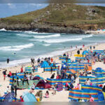 Holidaymakers Descend on Cornwall as Local Resident Criticizes Falmouth and Padstow While Tourists Overrun Beaches and Streets in Peak Summer Season Across Cornwall