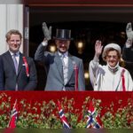 King Harald and Queen Sonja Wave from Royal Palace Balcony in Oslo Norway as Constitution Day Crowds Celebrate Nation’s Freedom