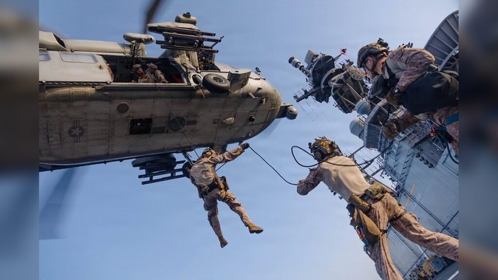 U.S. Marines from the 31st Marine Expeditionary Unit rappel out of an MH-60S Sea Hawk