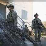 The reaction from Germany was notably calm after news emerged that the United States planned to pull back around 5,000 troops from its overseas deployment. The response from Boris Pistorius summed up the mood in Berlin: this wasn’t seen as a shock move, but something long anticipated in defence circles. Rather than panic or alarm, officials treated it more like a planned adjustment in an evolving security landscape. Pistorius himself made it clear that such a shift had been expected, given broader changes in US military posture and global priorities. A Longstanding US Military Presence in Europe For decades, the United States has maintained a significant military footprint across Europe, with Germany serving as one of its key hubs. US forces have been stationed there as part of NATO commitments, deterrence strategy, and rapid-response capabilities. The announced reduction of about 5,000 troops doesn’t erase that presence, but it does reflect a gradual recalibration. Over time, Washington has signaled interest in redistributing forces, especially as attention shifts toward other global regions. Still, the presence of American troops in Germany remains central to NATO operations and collective defence planning. Pistorius Says the Move Was Expected, Not Alarming Speaking in response to the announcement, Pistorius downplayed any sense of crisis. His message was straightforward: this kind of troop adjustment had been on the radar for some time. Rather than framing it as a withdrawal of support, he described it as part of ongoing military planning between allies. In his view, it fits into a broader pattern where force levels are regularly reviewed based on strategic needs rather than sudden political decisions. That tone matters in Berlin, where officials are careful not to overreact to shifts that are still within alliance frameworks. What the Change Could Mean for European Security Even if the reduction is relatively modest in scale, any change in US troop levels in Europe naturally raises questions about readiness and deterrence. For NATO allies, the key concern is not just numbers, but capability—how quickly forces can be deployed, how well coordination works, and whether gaps are created in strategic coverage. Germany, as one of NATO’s central logistics and command hubs, is likely to remain a critical base regardless of troop adjustments. However, smaller footprints can still influence planning, training exercises, and rapid deployment capacity. A Signal of Shifting Global Priorities This move also reflects a broader pattern in US defence strategy. Over recent years, Washington has increasingly balanced its commitments between Europe, the Indo-Pacific, and other global regions. While Europe remains a core alliance priority, the redistribution of forces suggests a more flexible, global approach to military positioning. Allies in Europe have been gradually encouraged to strengthen their own defence capabilities as part of shared burden expectations within NATO. Impact and Consequences The immediate impact is limited in operational terms, but politically it reinforces an ongoing theme: Europe is being asked to take more responsibility for its own security structure. For Germany, the announcement is unlikely to change day-to-day defence operations, but it does feed into broader debates about military readiness, spending, and long-term strategic independence. Within NATO, it may also accelerate discussions about force sharing, readiness targets, and infrastructure upgrades across member states. What’s Next? The next step will likely involve coordination between US and NATO leadership to ensure the troop adjustment does not create operational gaps. Germany is expected to continue hosting a substantial US military presence, even after the reduction. At the same time, European allies may push for clearer timelines and assurances regarding future force levels. Further updates could also emerge as part of wider NATO restructuring discussions, especially as global security priorities continue to shift. Summary The US decision to withdraw around 5,000 troops from deployment in Europe has been met with calm acceptance in Germany. Defence Minister Boris Pistorius described the move as expected, framing it as part of routine strategic adjustment rather than a sudden shift. While the change is limited in scale, it contributes to ongoing conversations about NATO responsibilities and Europe’s role in its own defence. Bulleted Takeaways The US plans to withdraw around 5,000 troops from its overseas deployment German Defence Minister Boris Pistorius said the move was expected US military presence in Germany remains a key part of NATO defence structure The reduction is seen as part of broader global realignment of US forces NATO coordination is expected to manage any operational adjustments Europe continues facing pressure to increase its own defence responsibilities The change is more strategic than disruptive in immediate military terms