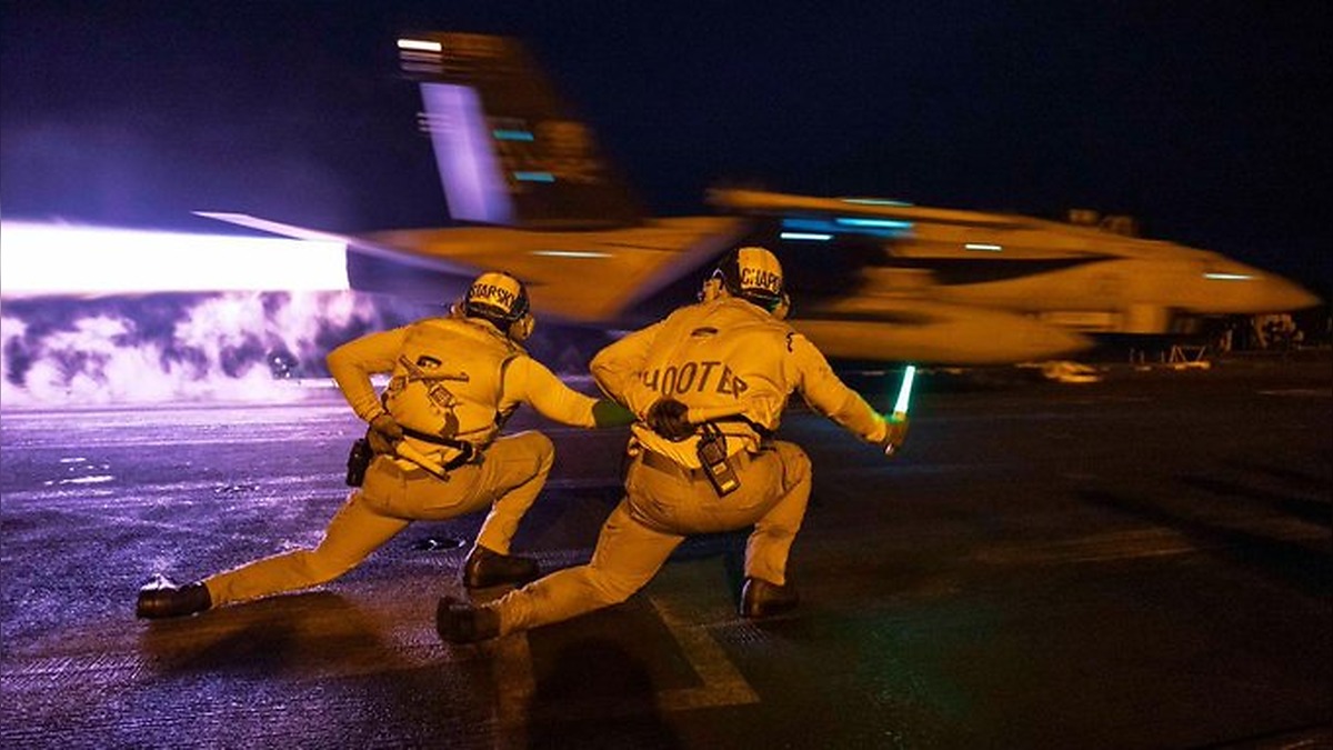 An F A 18 fighter jet launches from the flight deck of USS George H.W. Bush